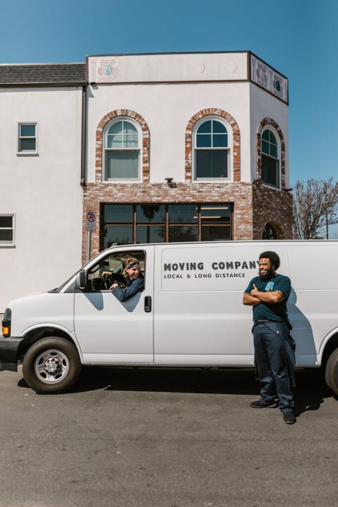 Moving company team with van parked outside building, ready for service.